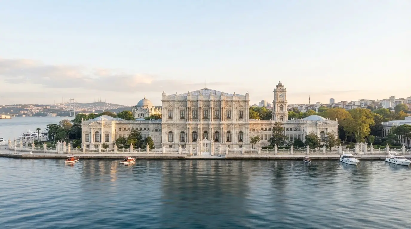 The waterfront façade of Dolmabahçe Palace along the Bosphorus, its ornamented stonework in daylight.